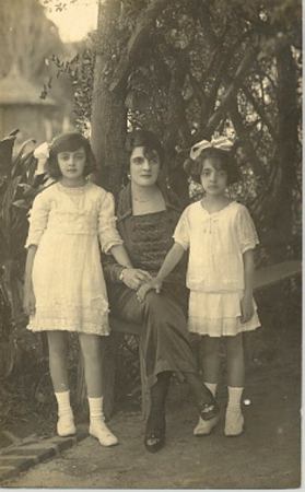 Marina (esposa de Alfredo Rui Barbosa), sentada entre suas duas filhas: Maria de Lourdes (à esquerda da foto) e Maria Luísa (à direita da foto). Original em postal, sépia.